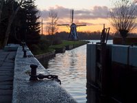 Vintage windmill backdrop  Vintage windmill backdrop during sunset with lock chamber foreground : Netherlands, aanleggen, aanmeren, atmosphere, boating, channel, dawn, dusk, groningen, holland, kanaal, knotwilg, landscape, landschap, lock, lock door, mill, molen, moor, mooring, nederland, orange, oranje, paterswolde, paterswoldsemeer, pleziervaart, rudmer zwerver, sailing, sfeer, sluis, sluisdeur, sunrise, sunset, vaart, water, water sports, watersport, willow, zonsondergang